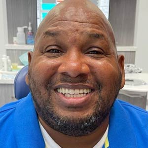 Smiling participant shown on the WVRF dental-care program page